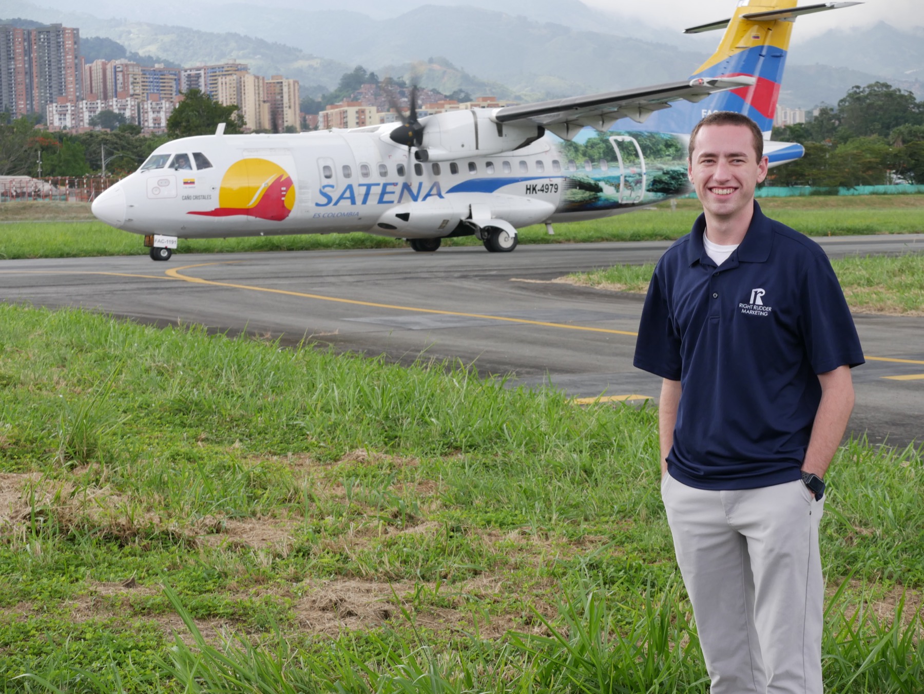 Sam Settle, flight instructor, on the ramp beside an aircraft